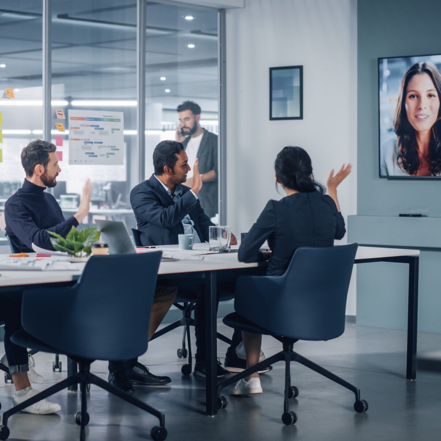 workers in a conference room on a video call